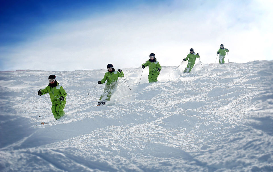 Snapshot of skier skiing down a small hill